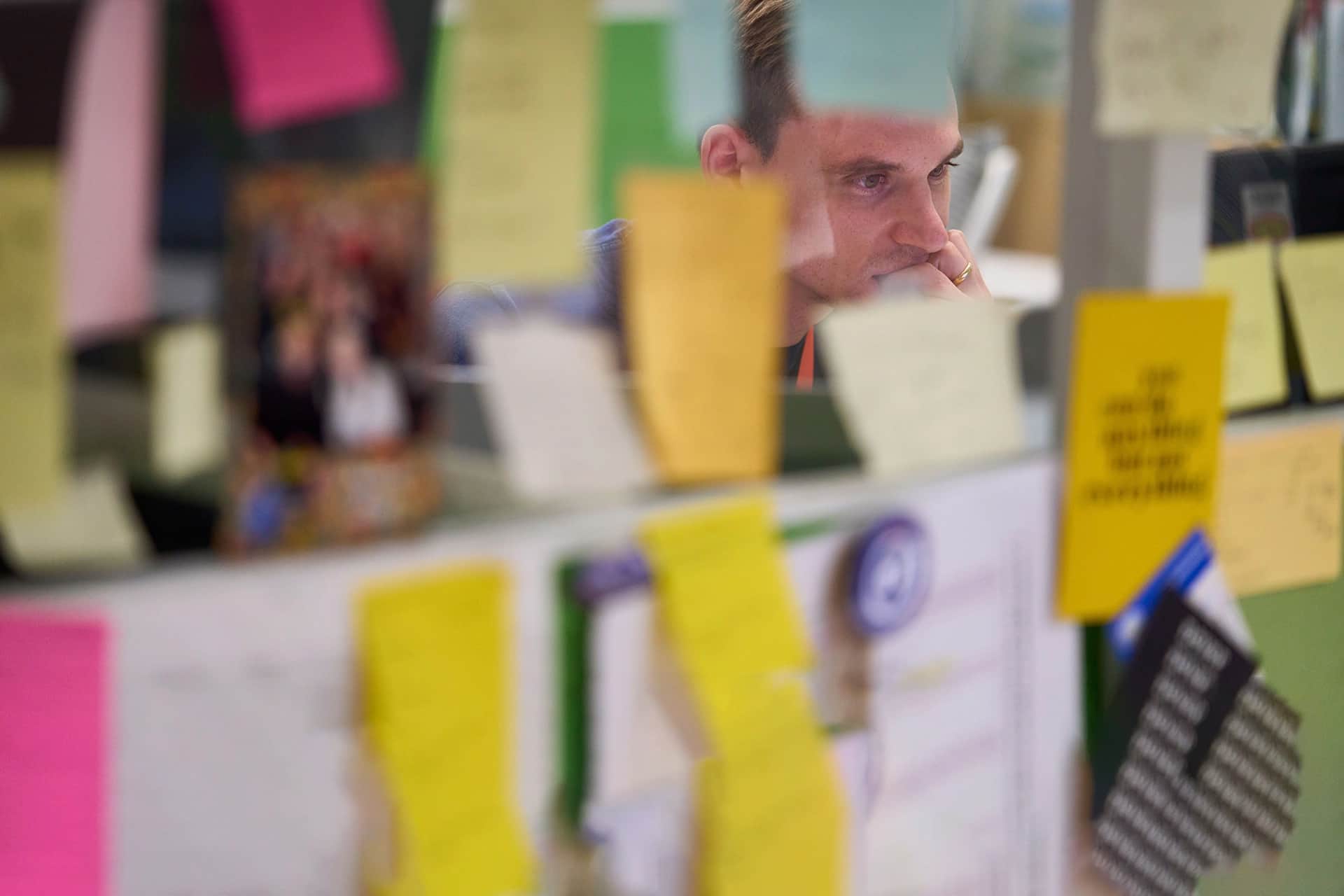 A photo of a man working at computer in an office.