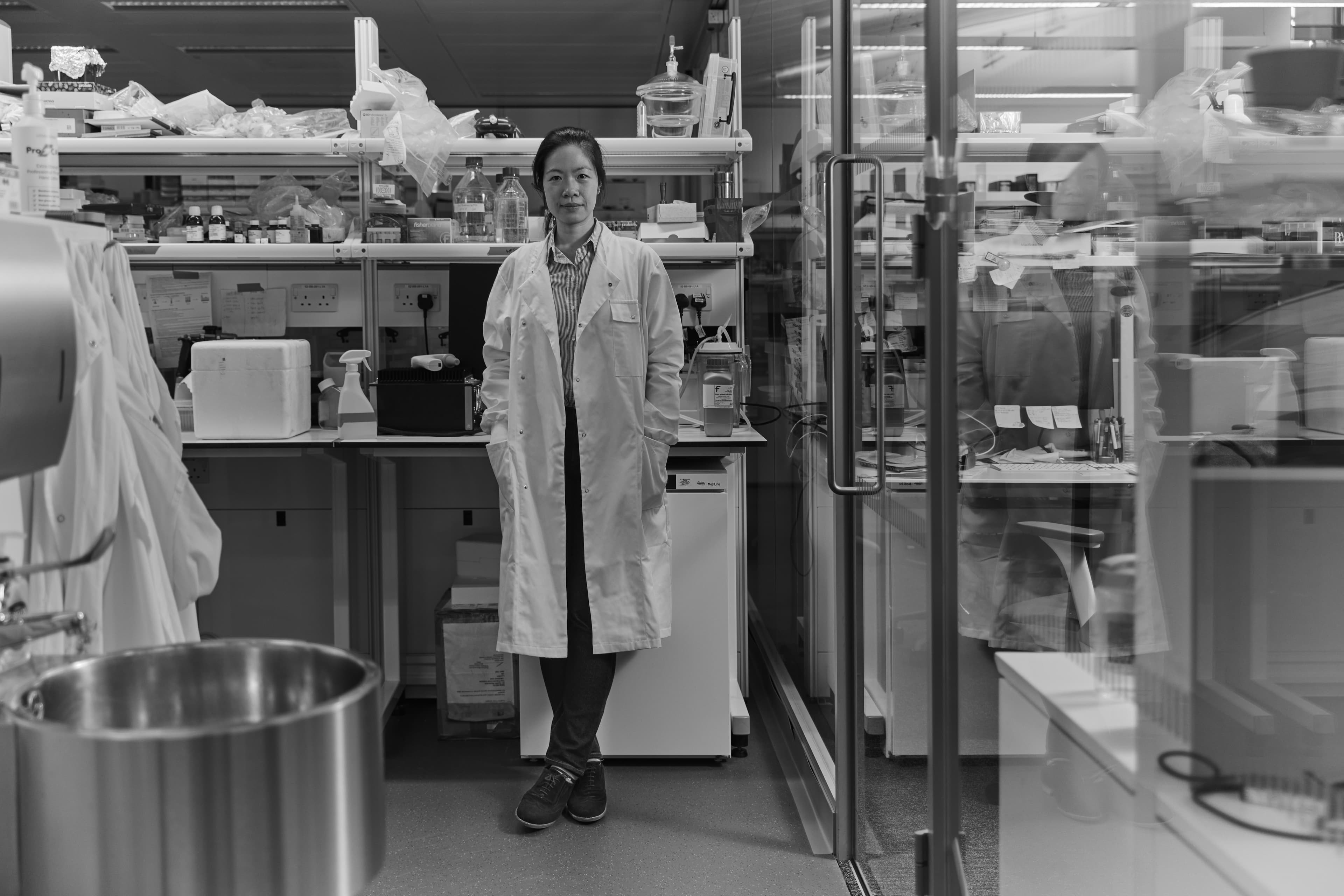 Image of researcher Leanne Li standing in a lab wearing a lab coat.