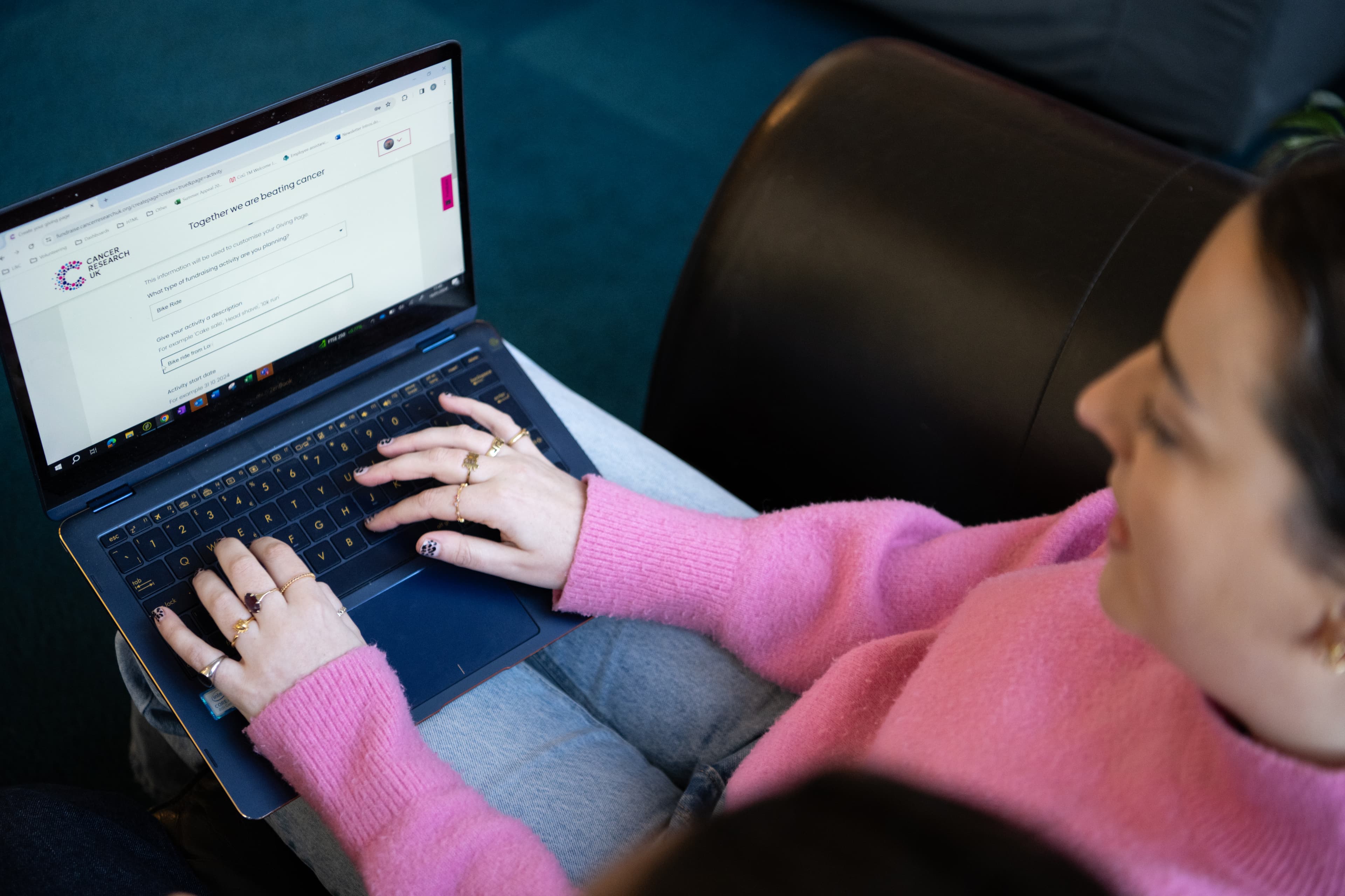 A woman on her laptop signing up to Payroll Giving.