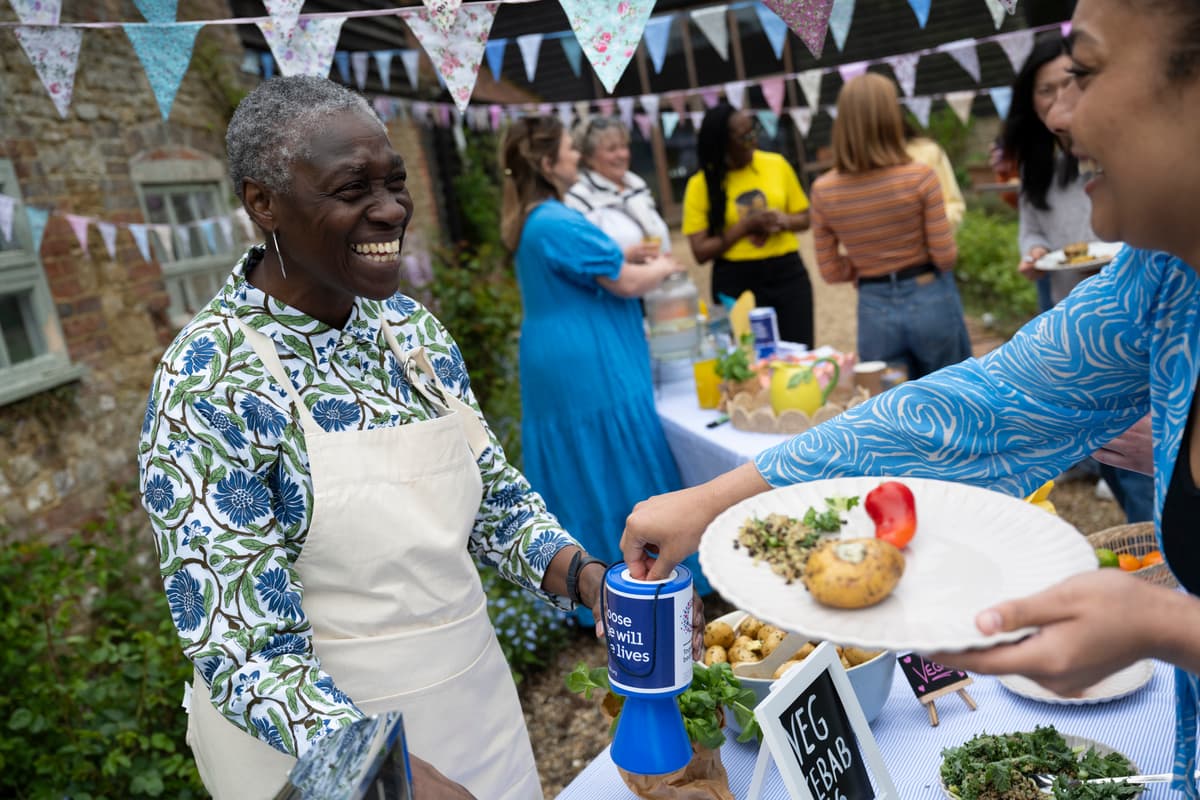 A photo of Cancer Research UK fundraisers getting ready for a food sale.