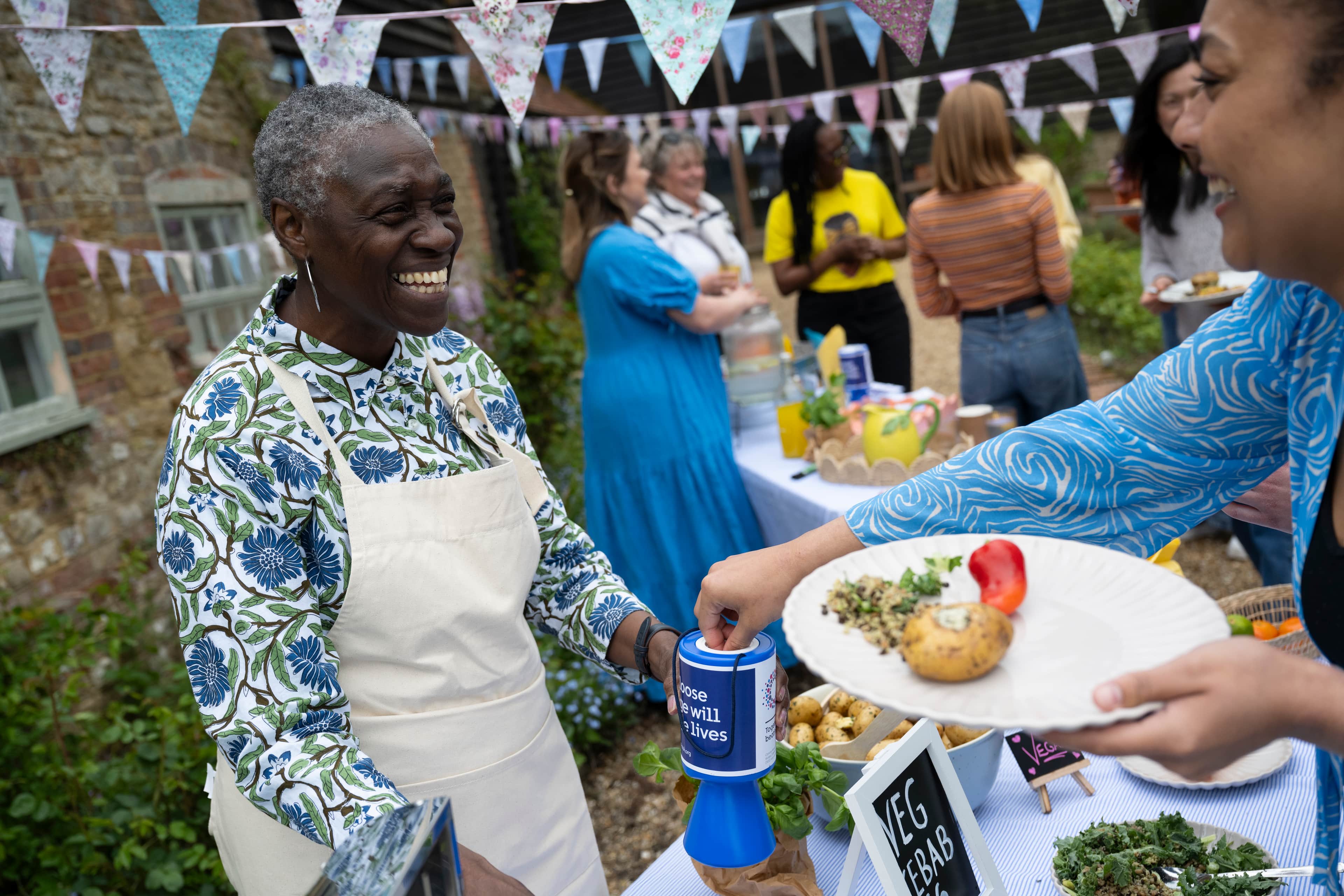 A photo of Cancer Research UK fundraisers getting ready for a food sale.