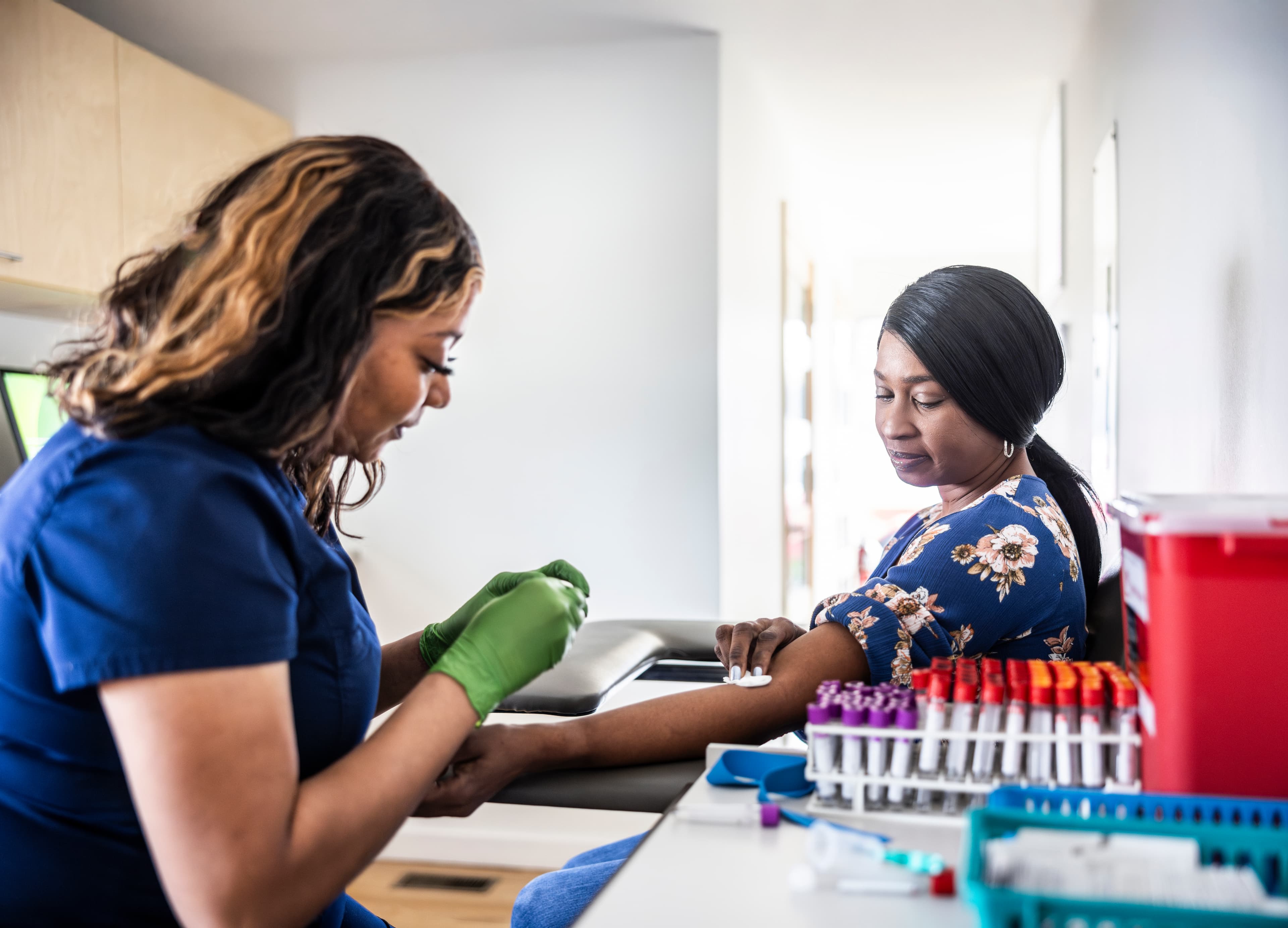 A photo of a healthcare professional taking blood from a patient.