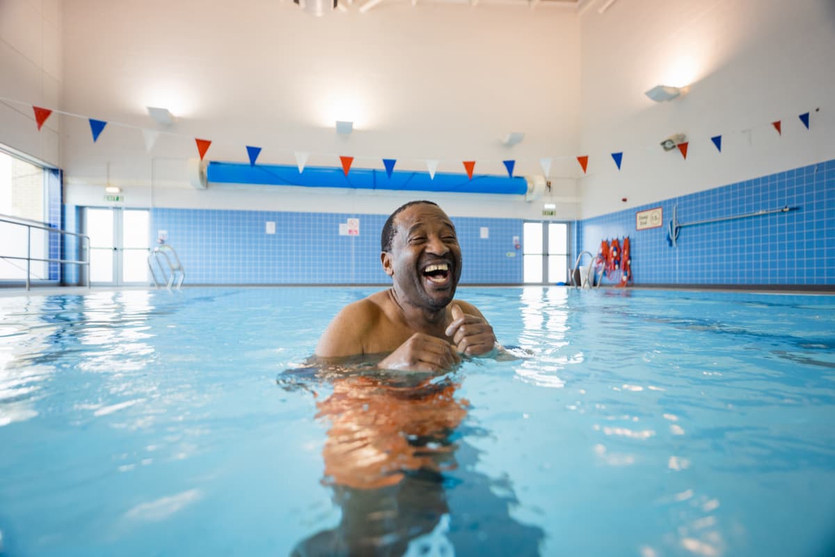 Man in swimming pool with bunting.