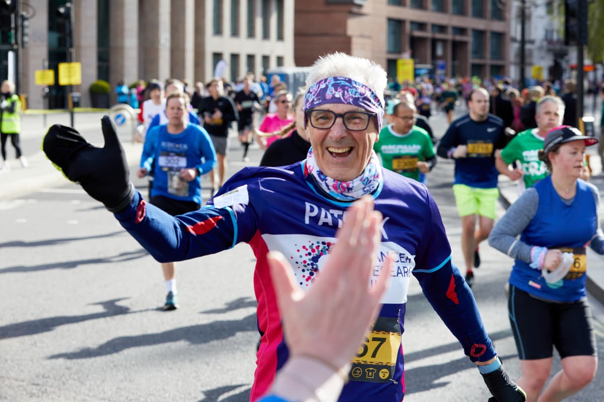 Marathon participant smiling and ready to high-five.