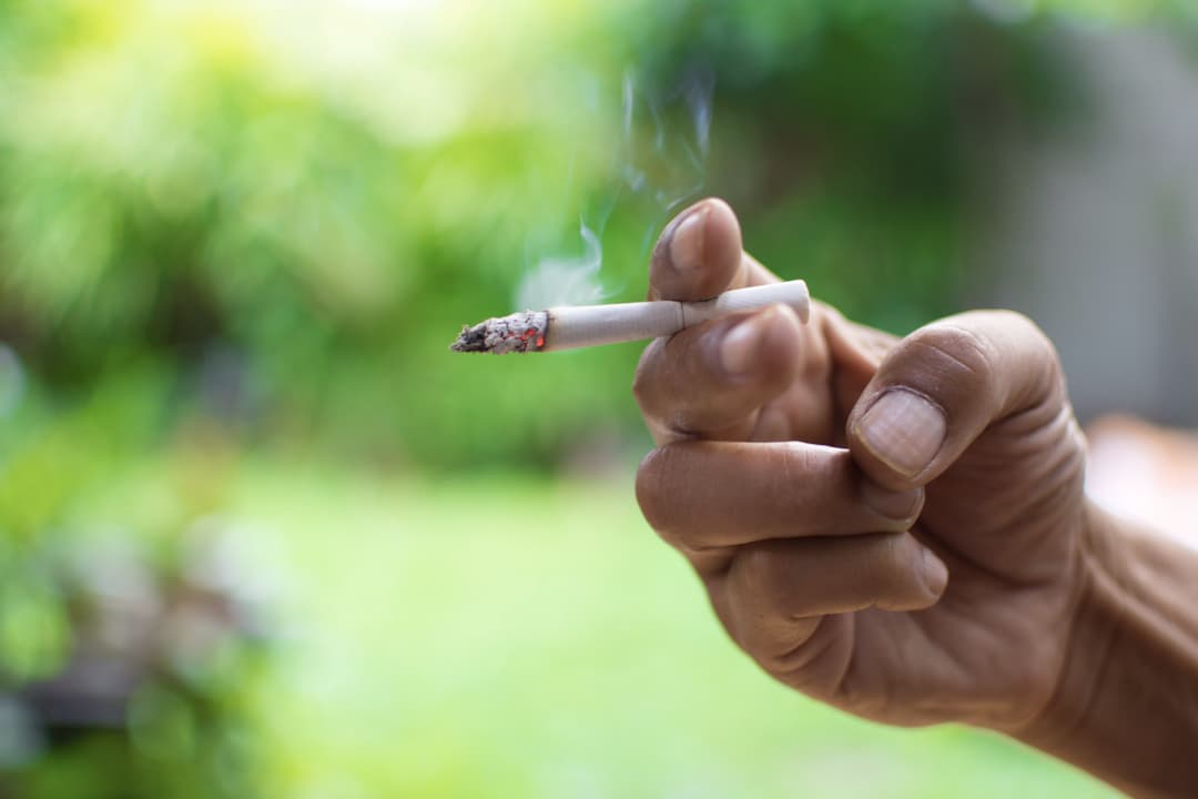 Smoking a cigarette.