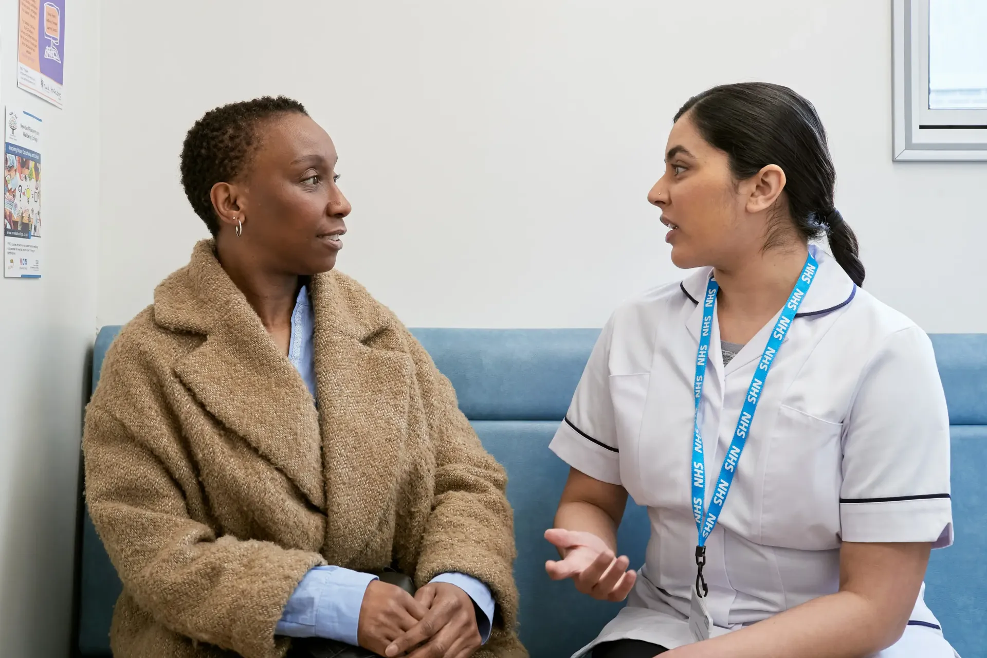 This photo shows a patient and mamographer in the waiting room of a mobile breast screening unit.