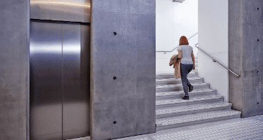 Photograph showing a woman climbing stairs.