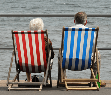 Photograph of couple sitting on deckchairs.
