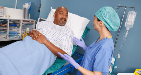 Photo of a man meeting an anaesthetist before surgery.
