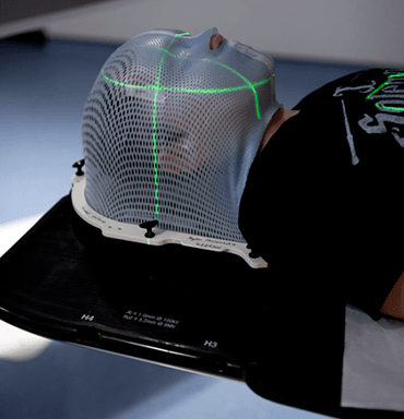 Photograph of child in radiotherapy mask close up.