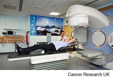 Photo of a women having radiotherapy for breast cancer.