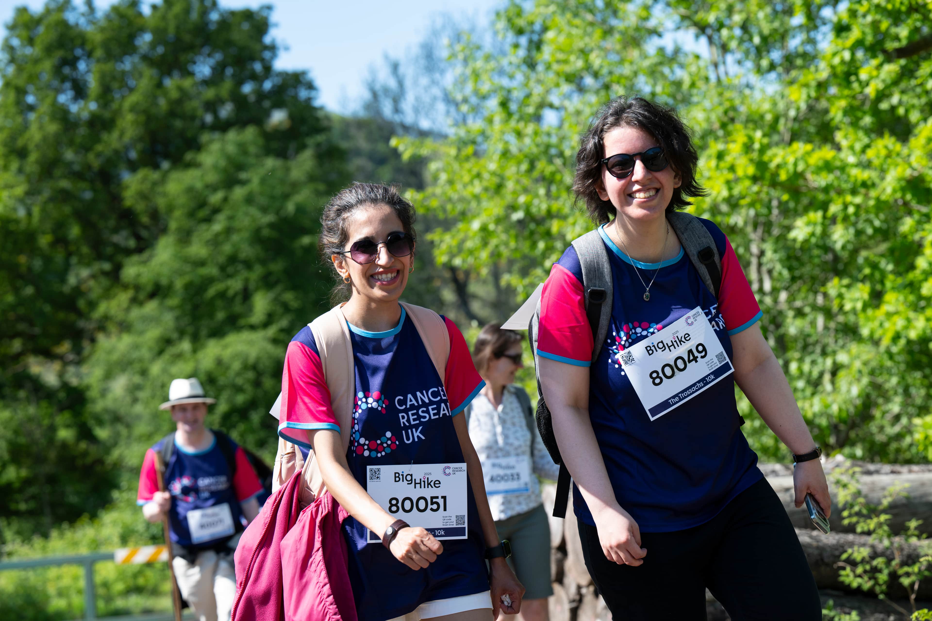 Two hikers smiling at the camera.