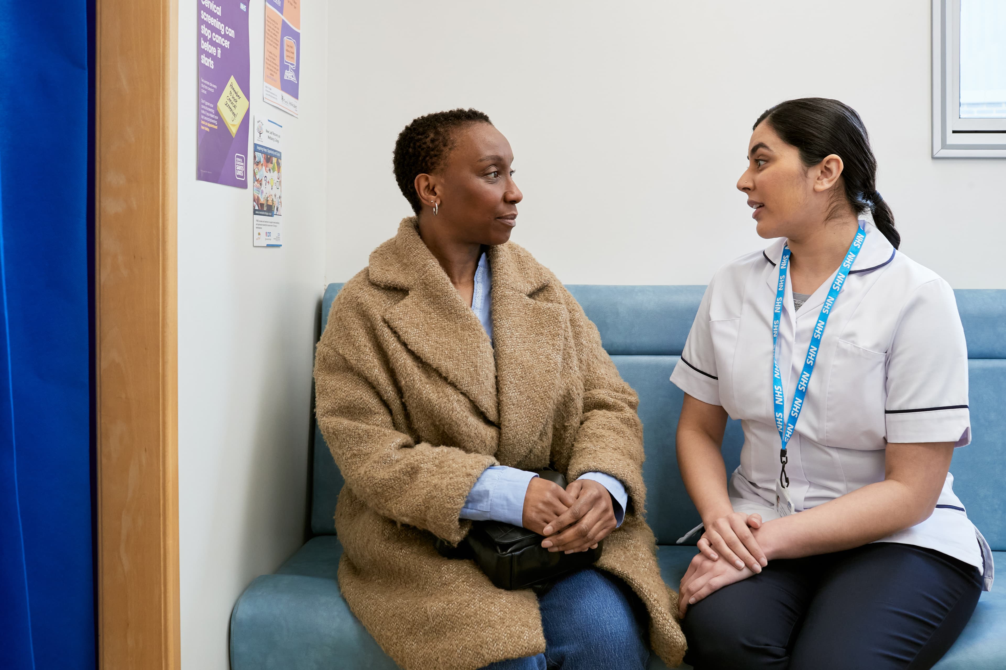 A photo of a patient and mamographer in the waiting room of a mobile breast screening unit.