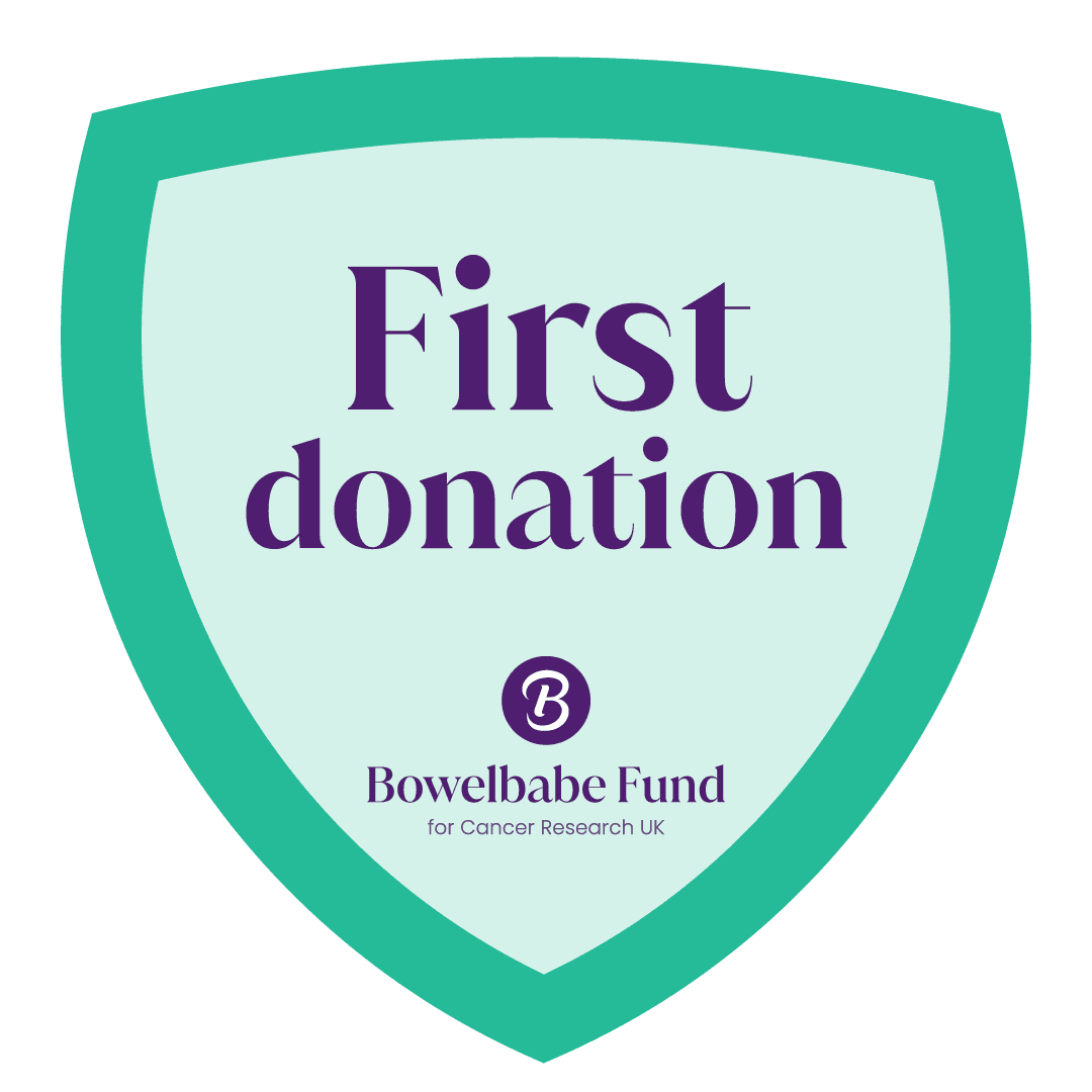 Shield-shaped badge with text “First donation” and Bowelbabe Fund for Cancer Research UK logo.