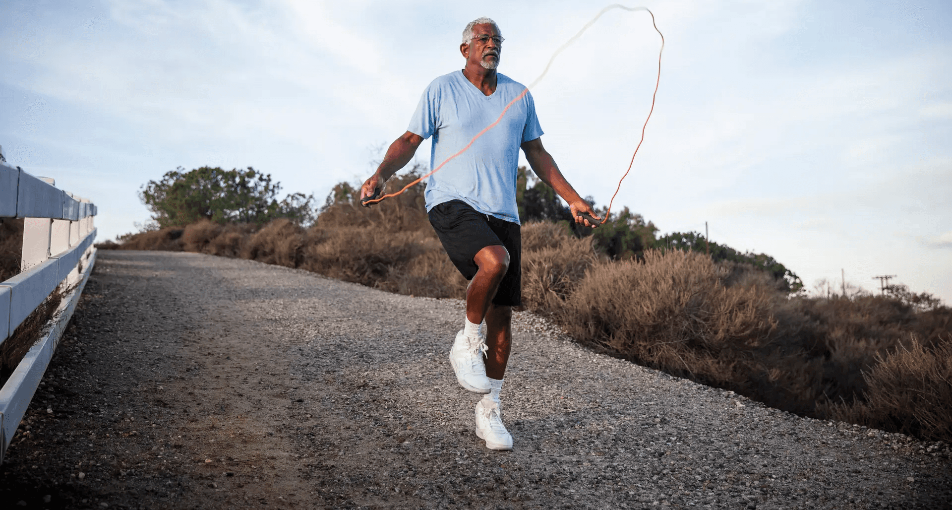 a man skipping outdoors.