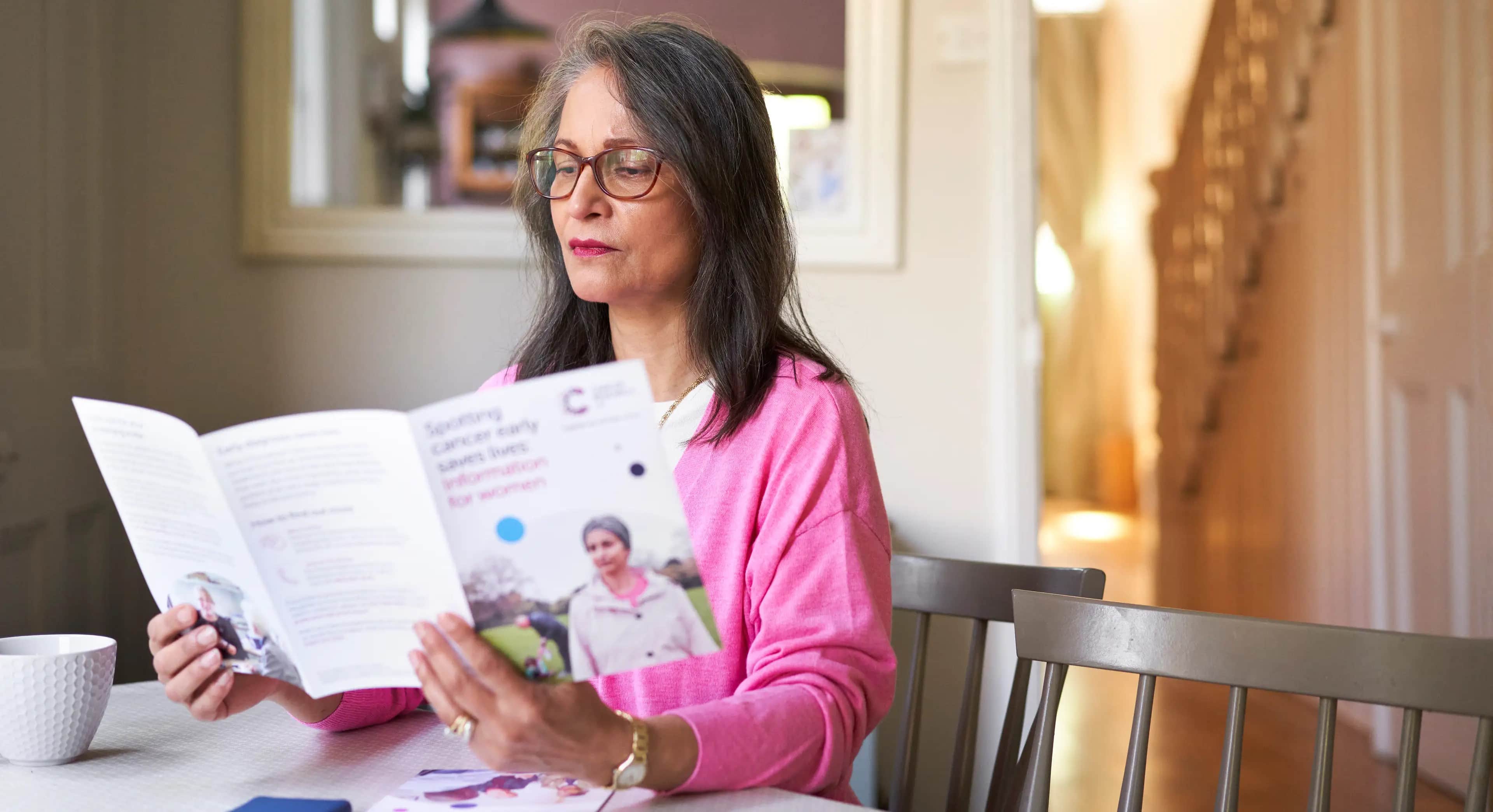 Woman reading in pink.