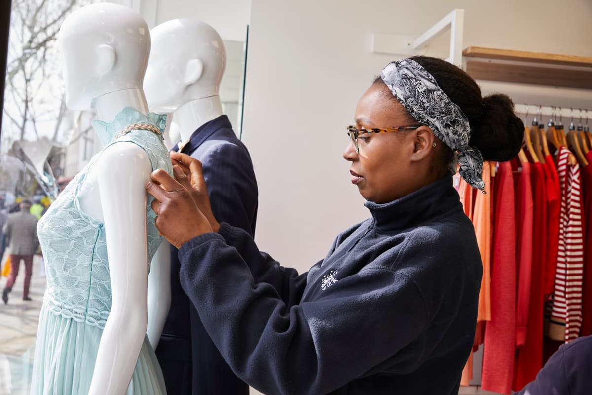 A photo of a voluteer at a Cancer Research UK charity shop.