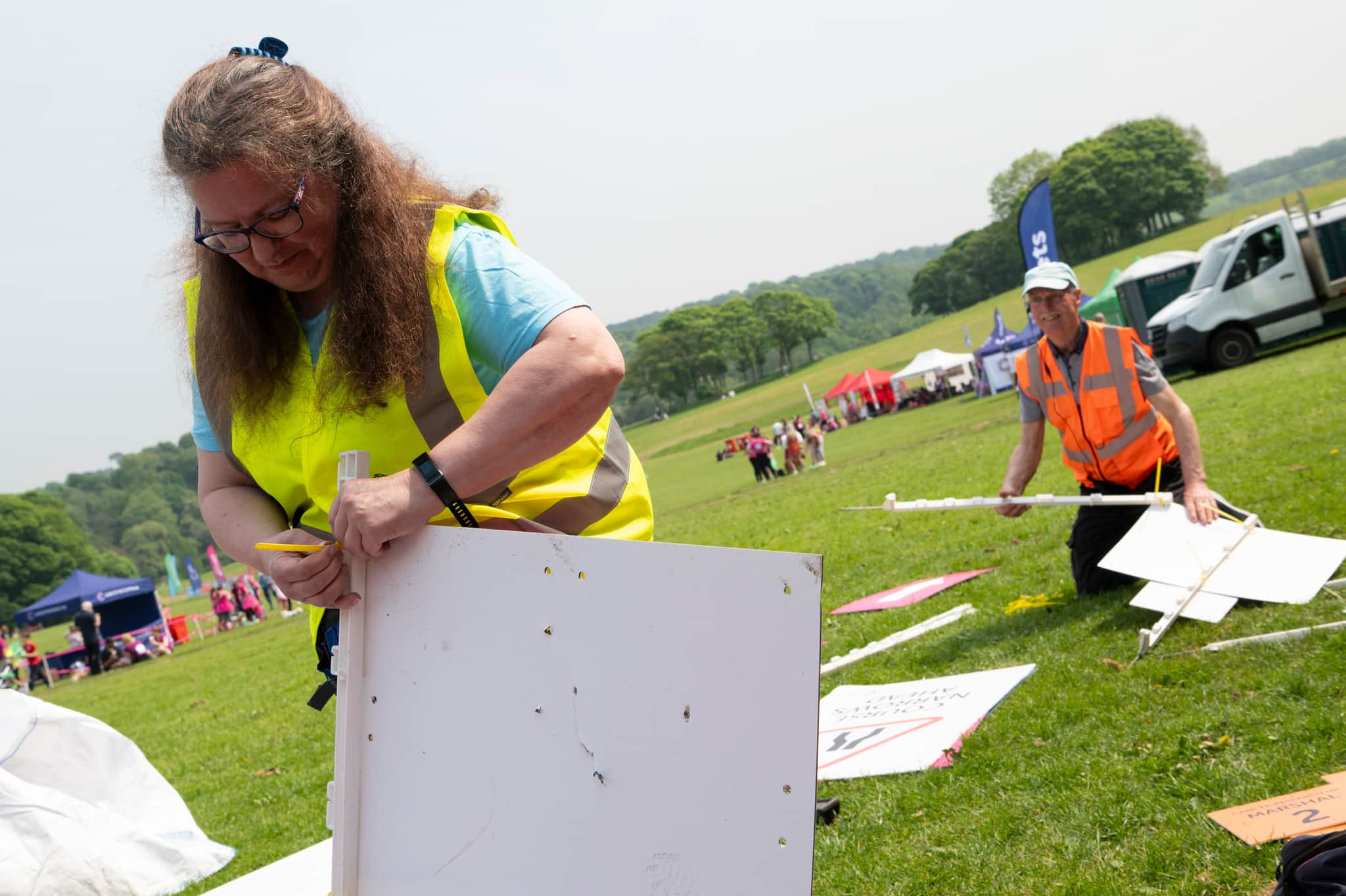 Image of volunteers building a marquee at an event.