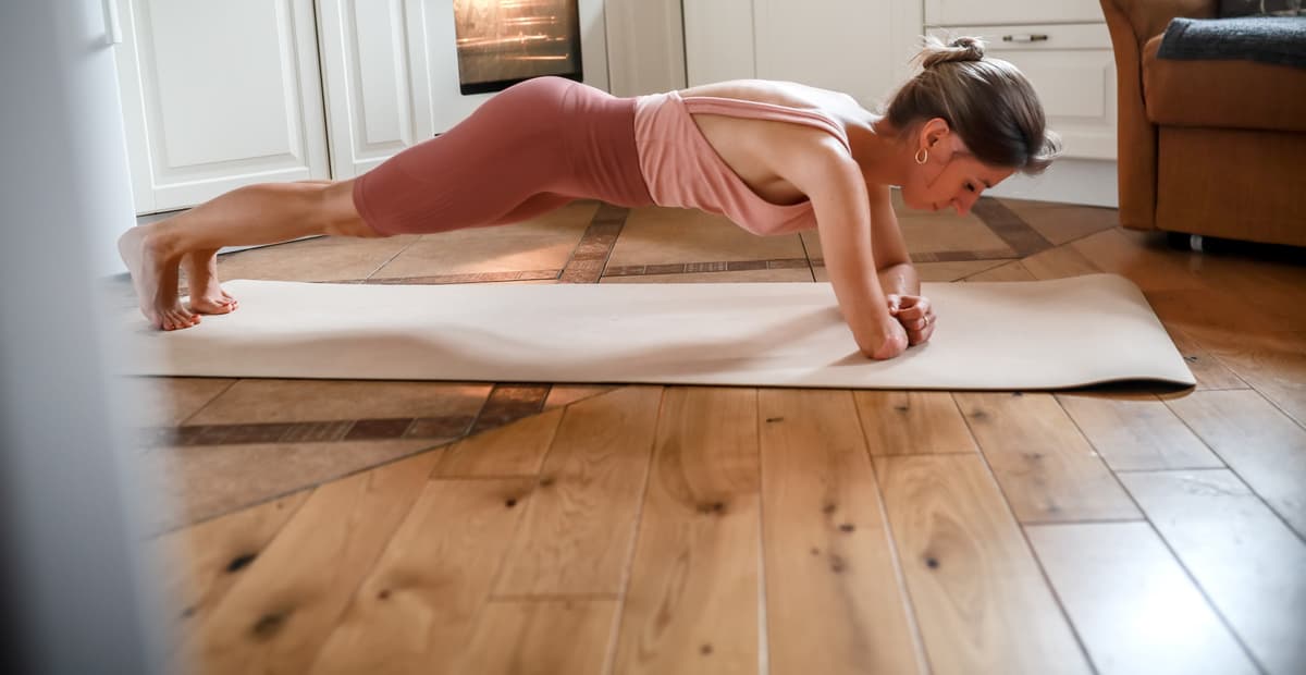 A picture of a women holding a plank.