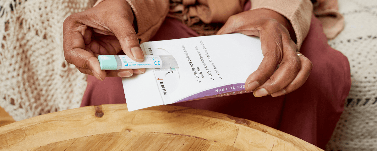 This photo shows a woman opening a Faecal Imunochemical Test.