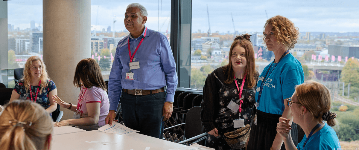 A photo of panel members in a meeting having a laugh.
