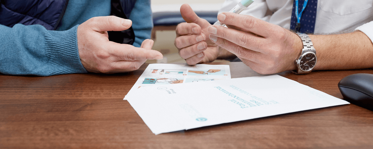 Image showing male hands looking at FIT documentation.