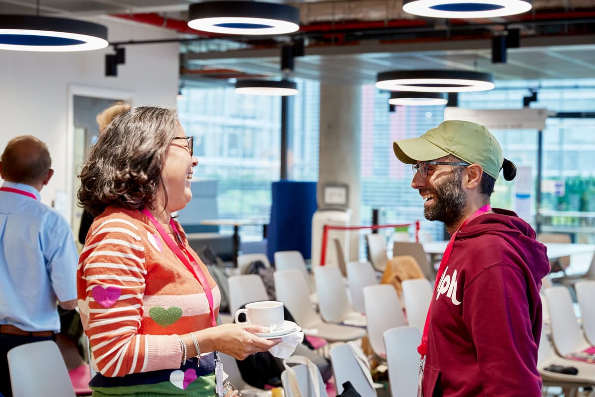 A photo of two patient involvement network members talking.