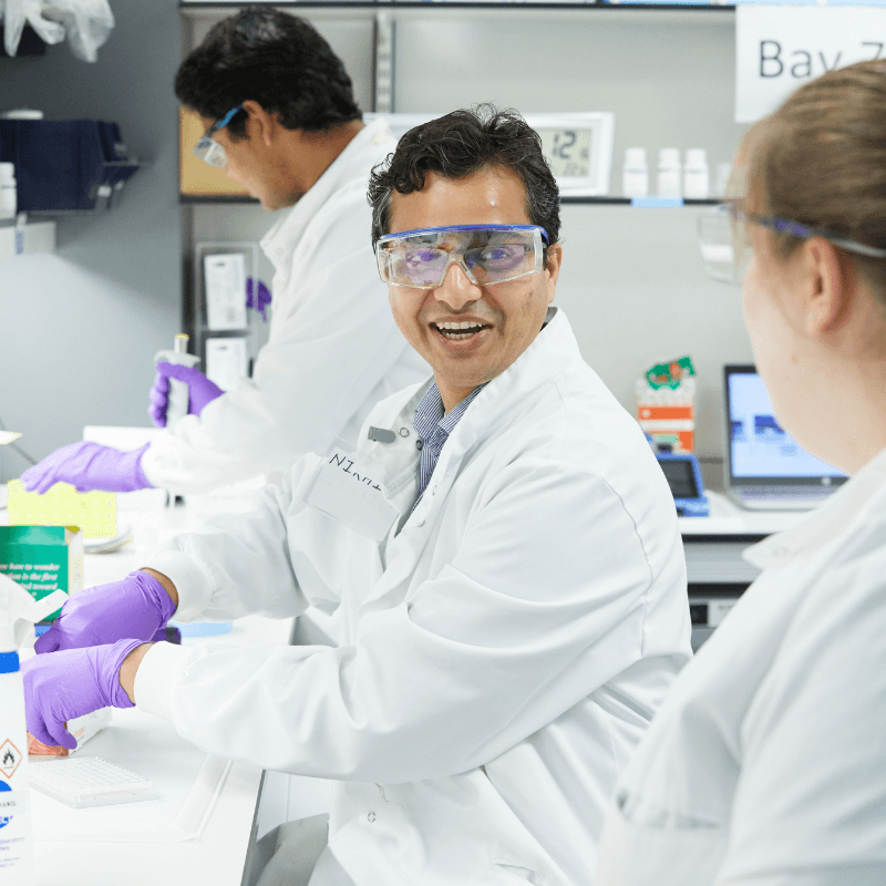 Three researchers working in lab.