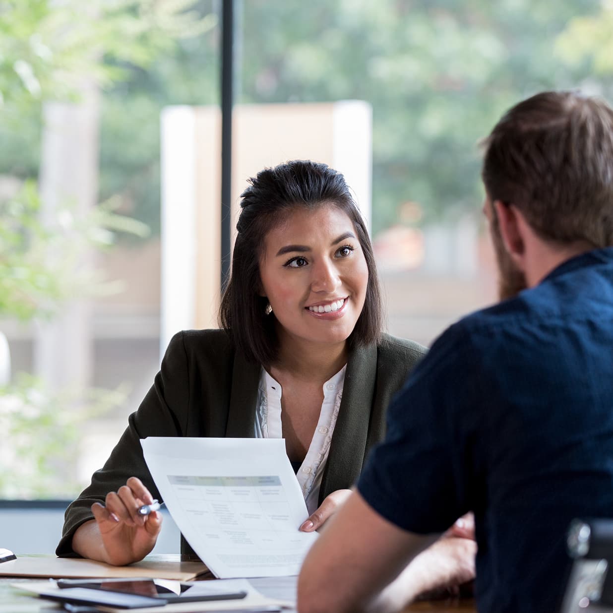 Solicitor smiling while looking across the table.