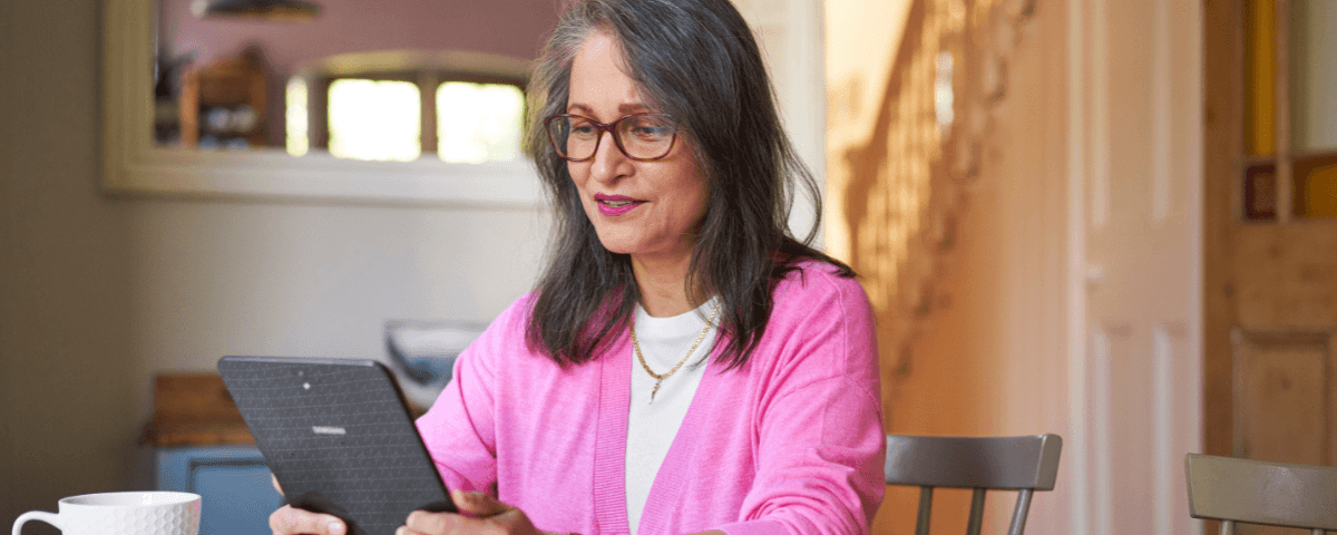 Photo of a woman at home using her tablet.