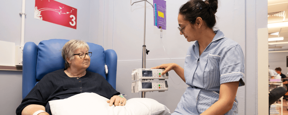A patient is receiving chemotherapy treatment from a health professional.