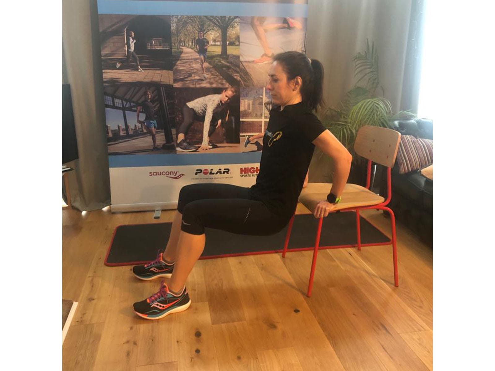 A person doing triceps dips using a chair.