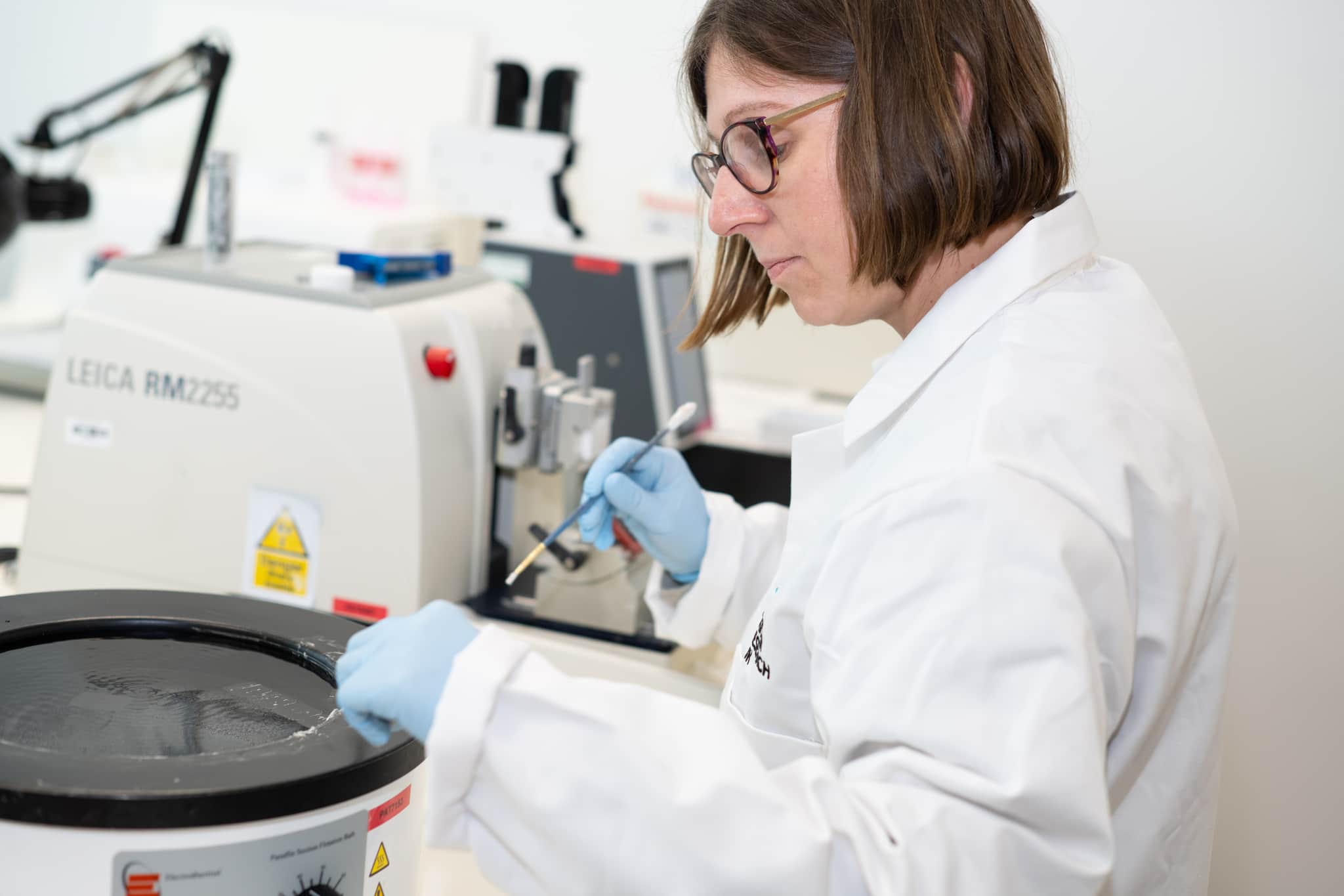 A researcher using equipment in a lab.