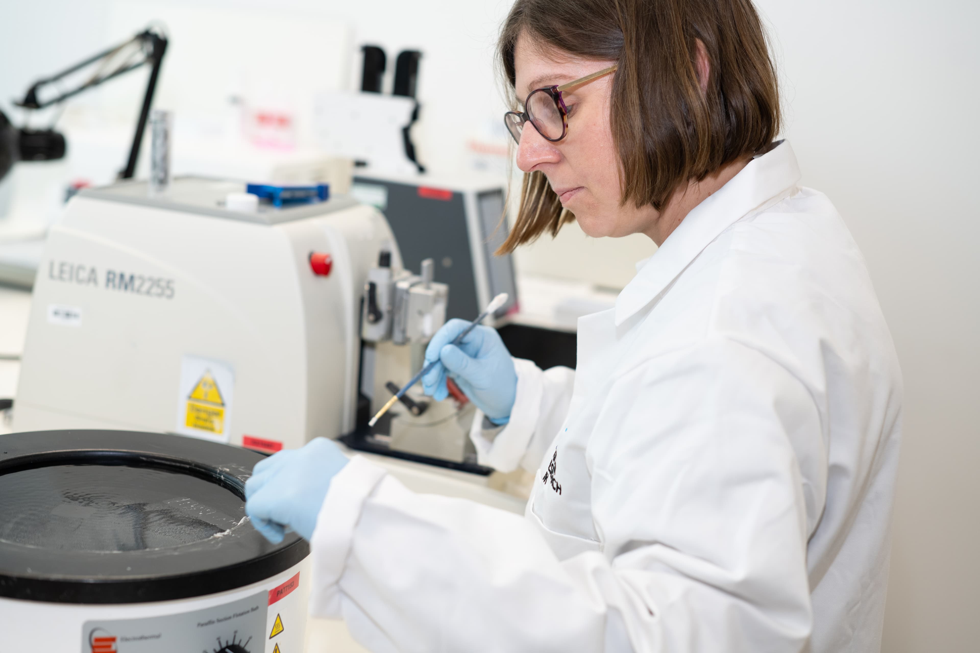 A researcher using equipment in a lab.