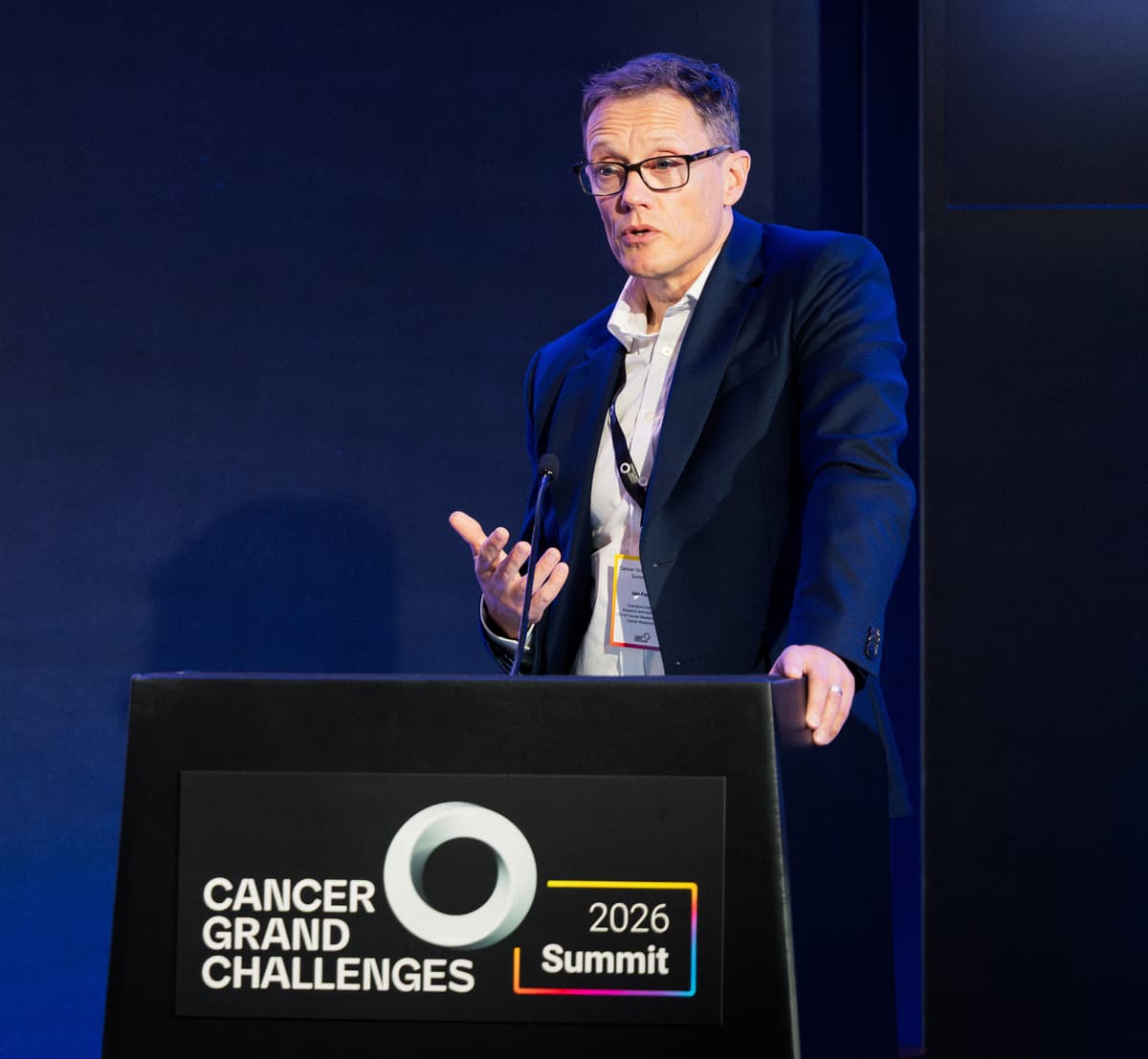 Iain Foulkes speaking at the Cancer Grand Challenges Summit 2026.