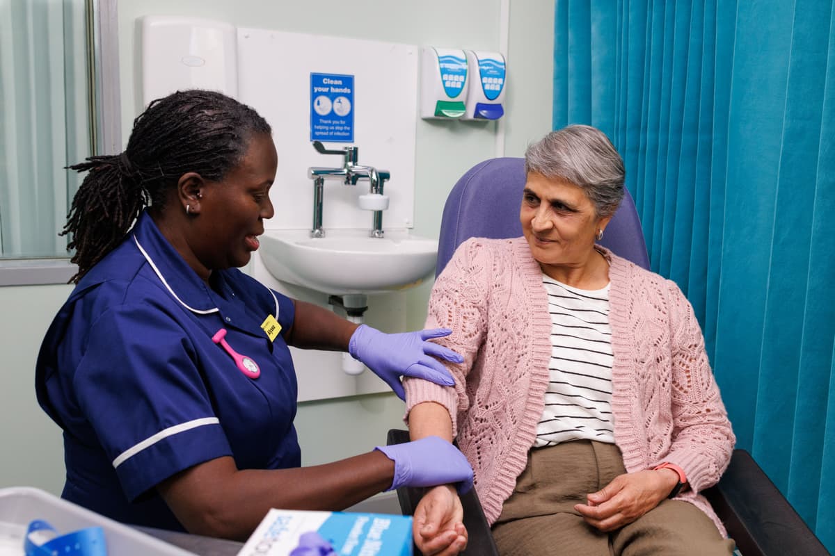 Research nurse giving a patient treatment.