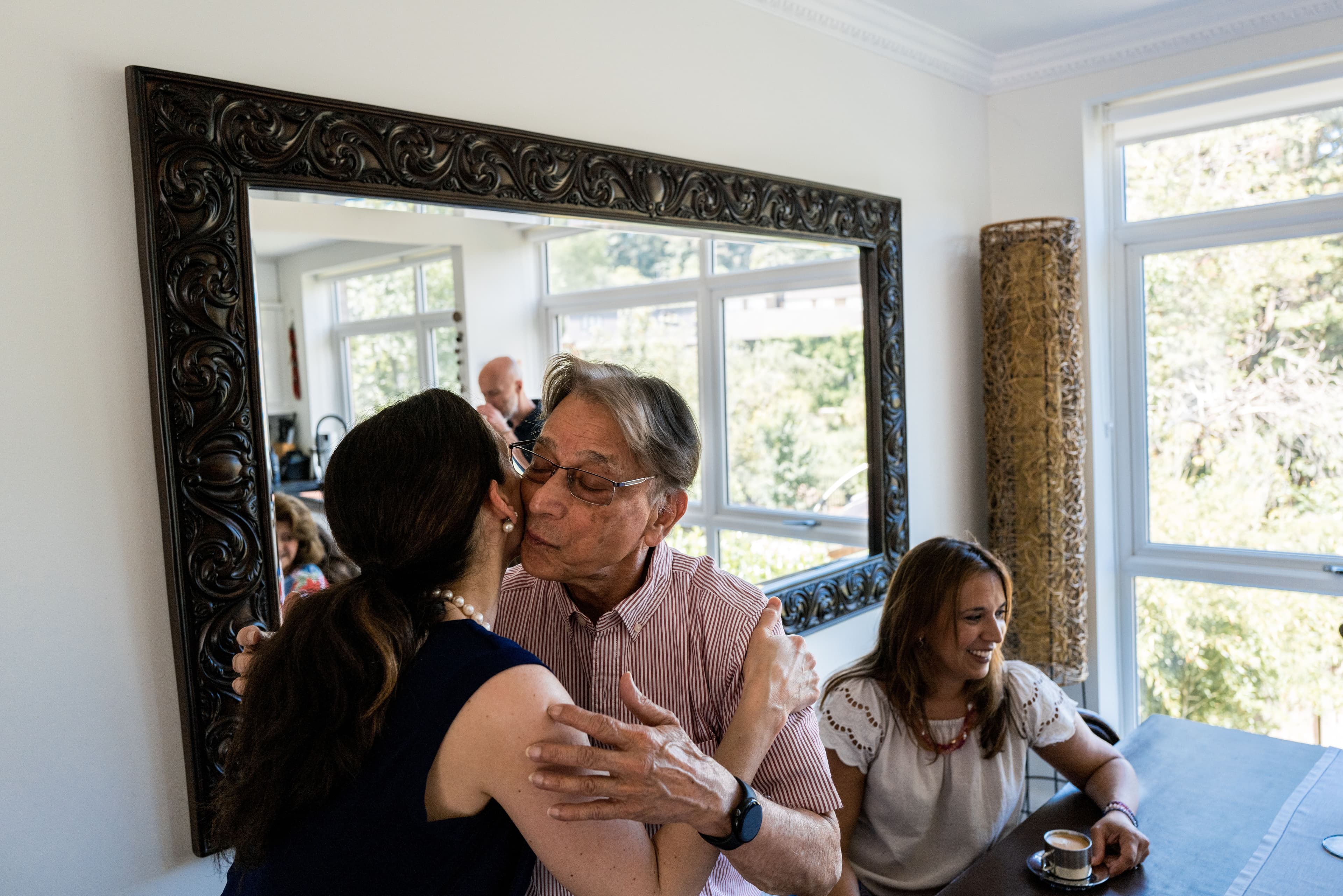 A photo of two people hugging and kissing.