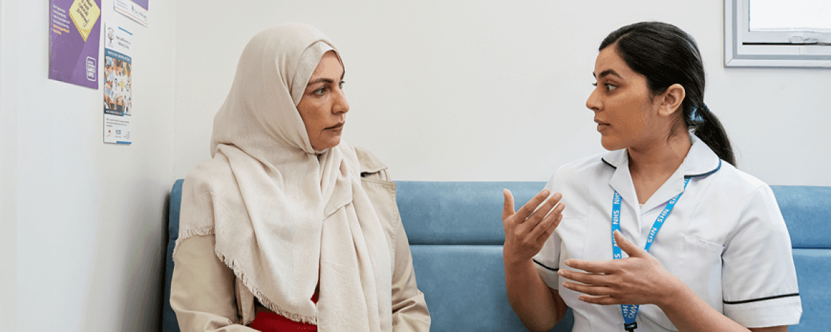 A healthcare professional talking to a patient.