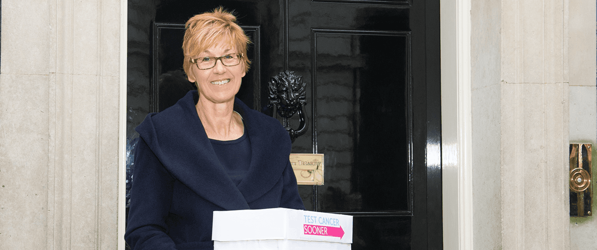 A photo of a Campaigns Ambassador in front of number 10.