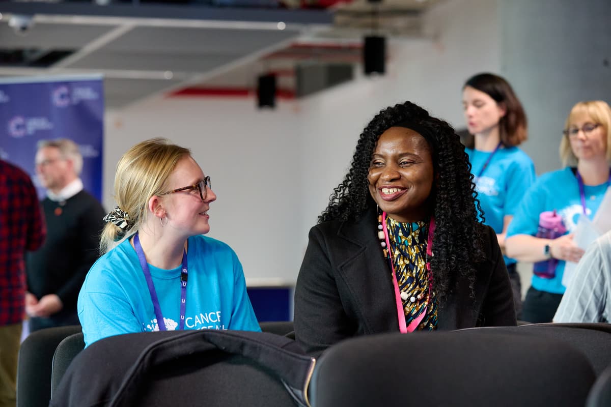 A photo of panel members in a meeting.