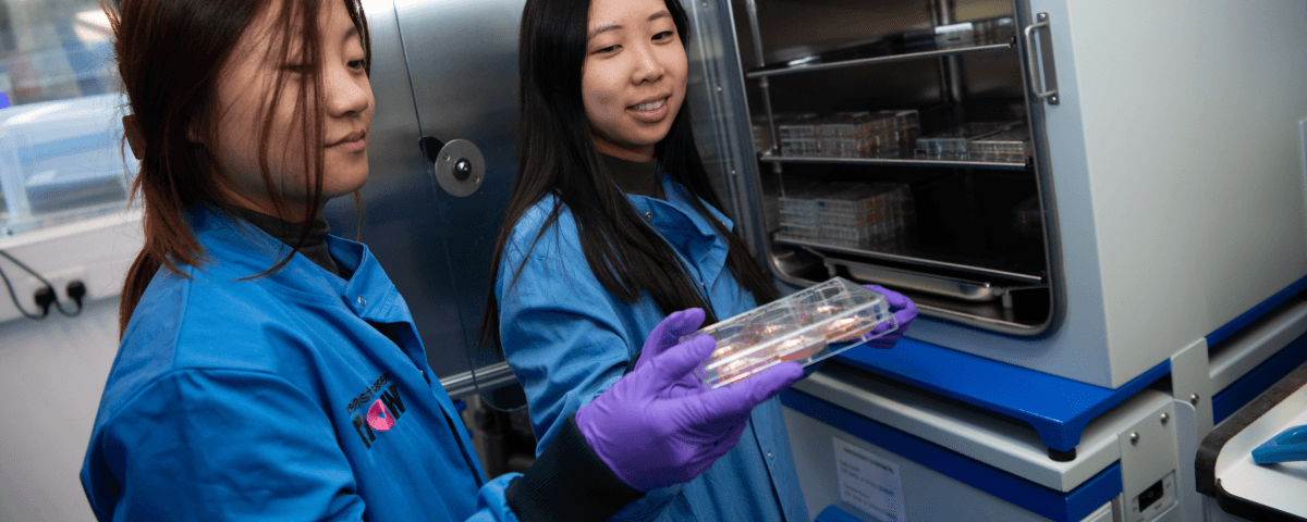Researcher getting samples from a fridge.