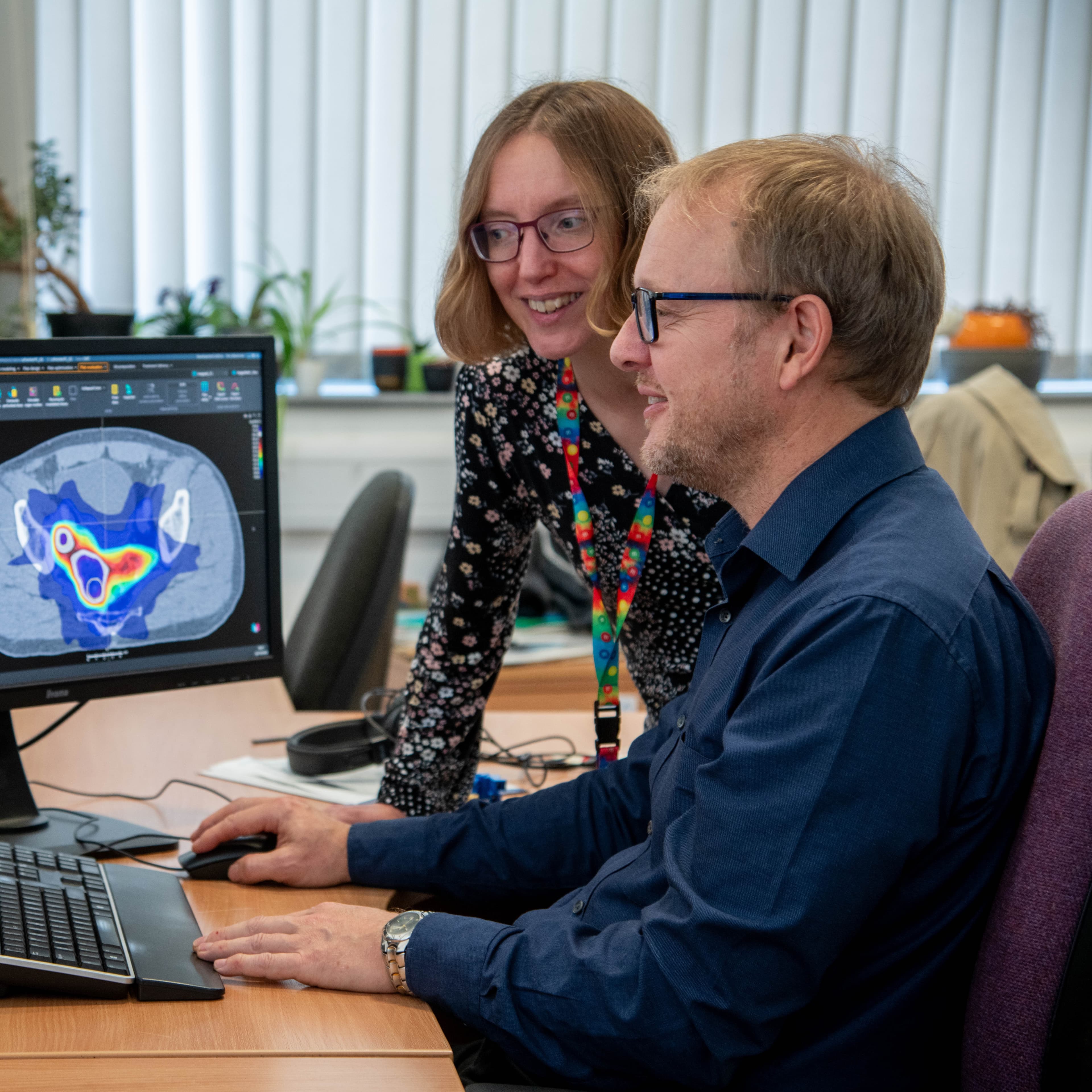 Researchers looking at a computer screen together.