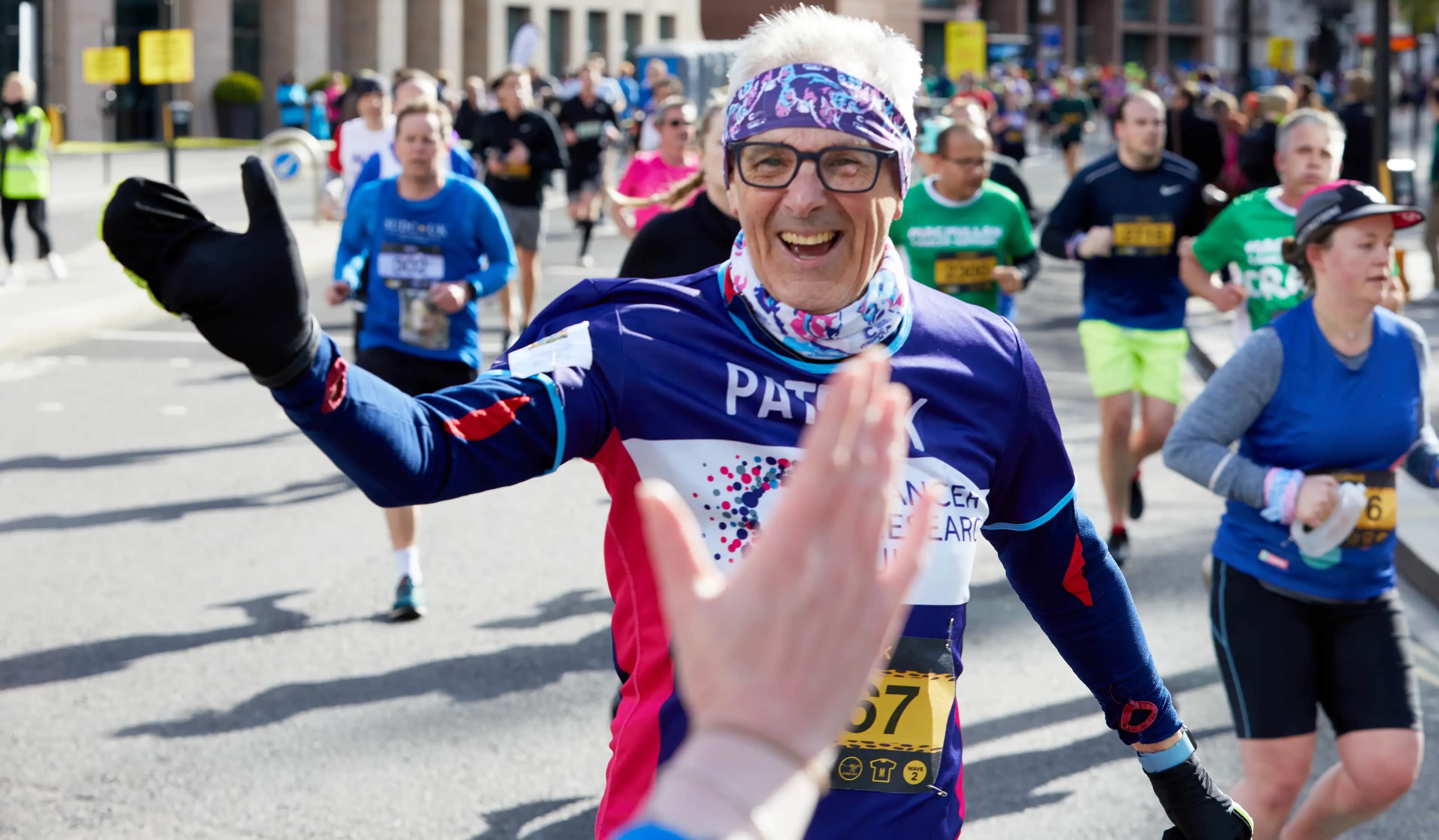 Marathon participant smiling and ready to high-five.