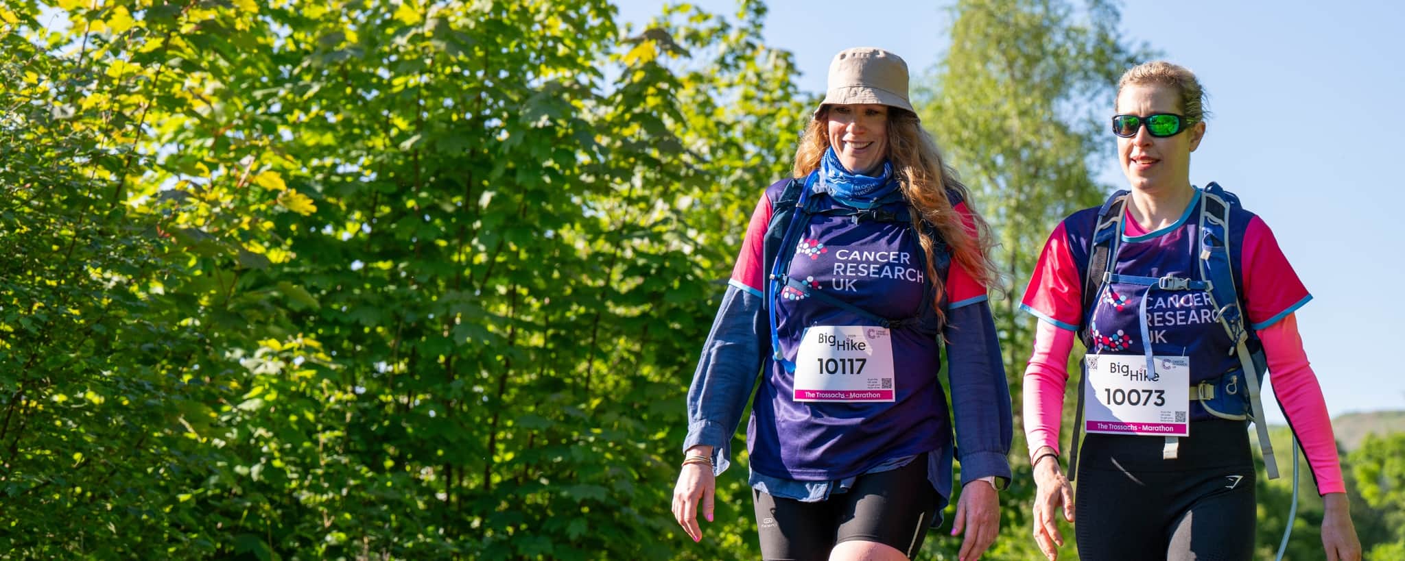 Two hikers smiling at the camera.
