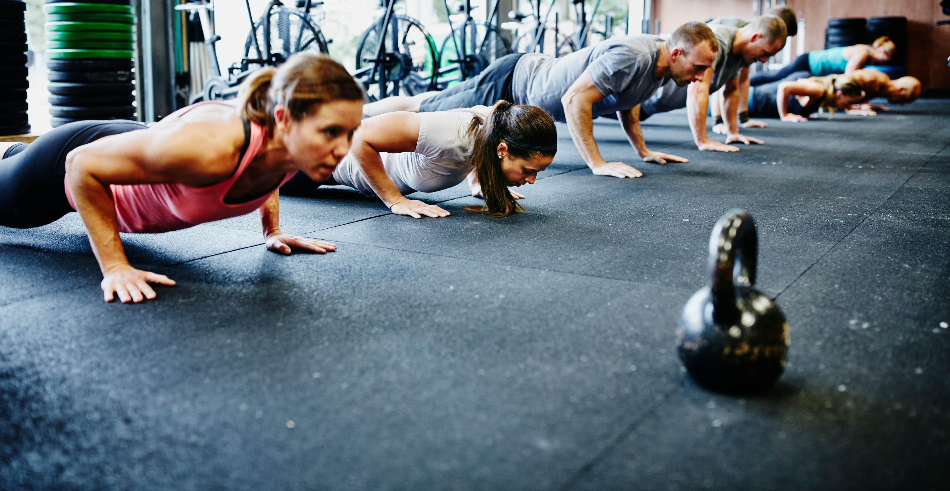 woman doing push up indoors.