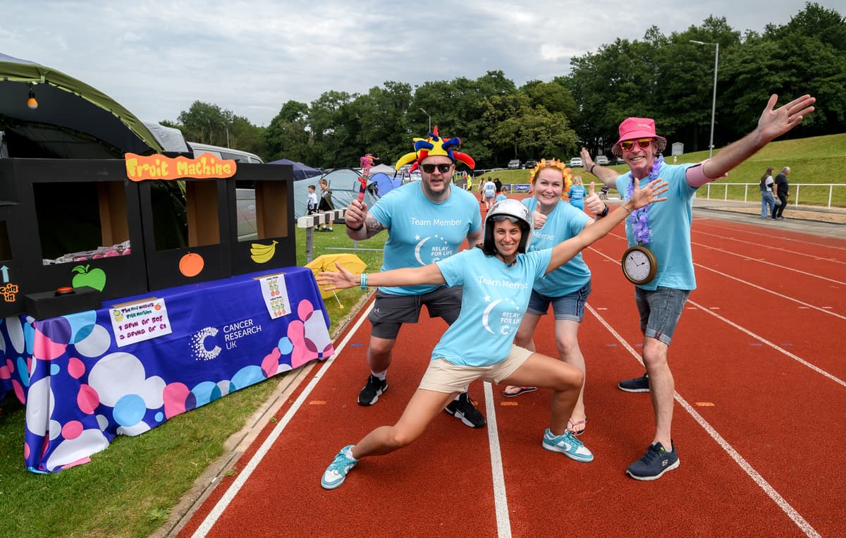 A photo of four people wearing Relay for Life t-shirts.