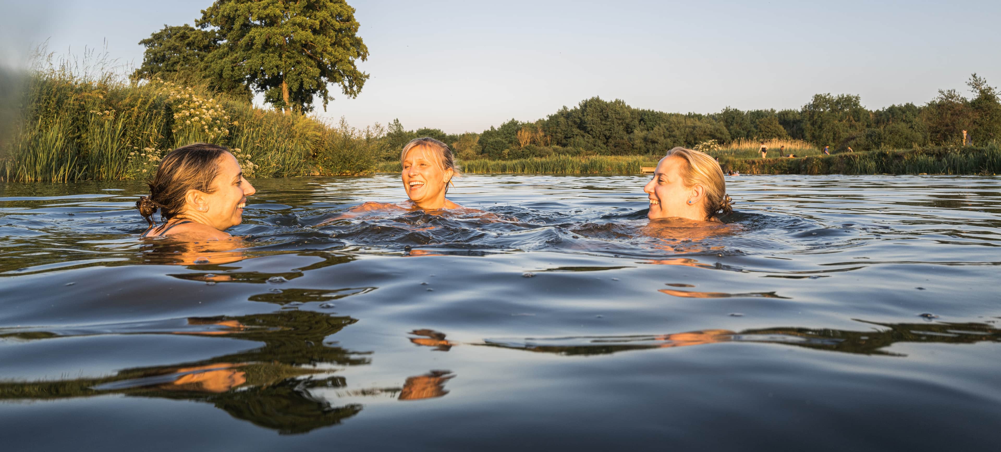 Shots of friends swimming in the wild greens.