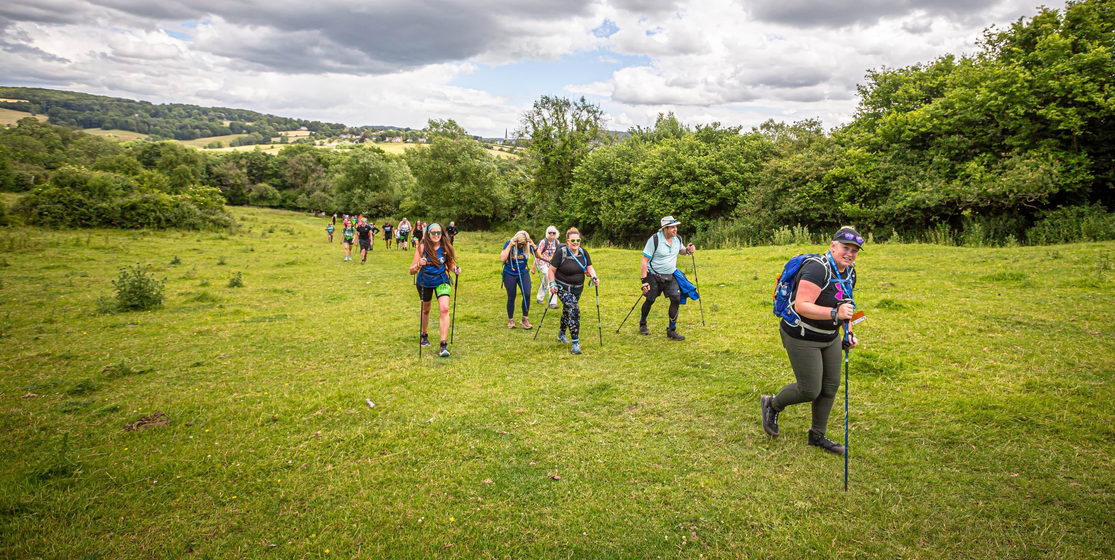 A group of walkers walking in a field.