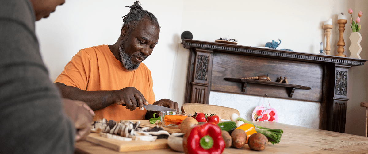 A photo of two men preparing a healthy meal.
